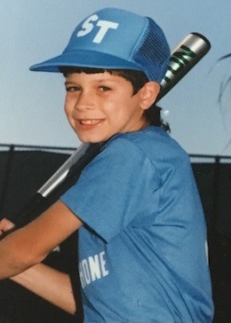 A young Philippe Papillon swinging a baseball bat